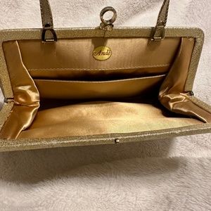 Ande clutch/hand bag with metal handle